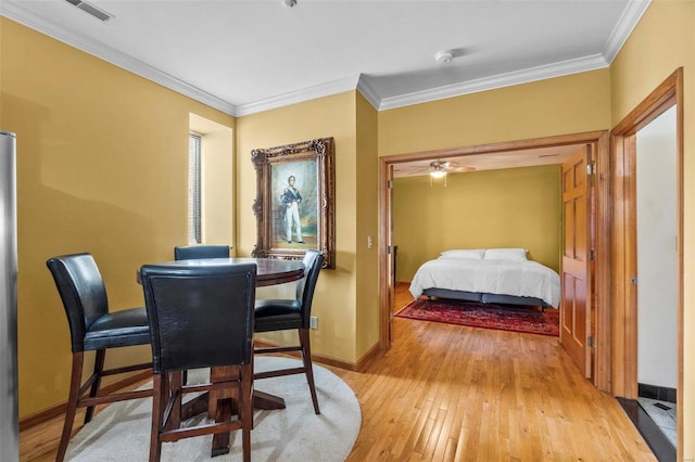 bedroom with ornamental molding and light hardwood / wood-style floors