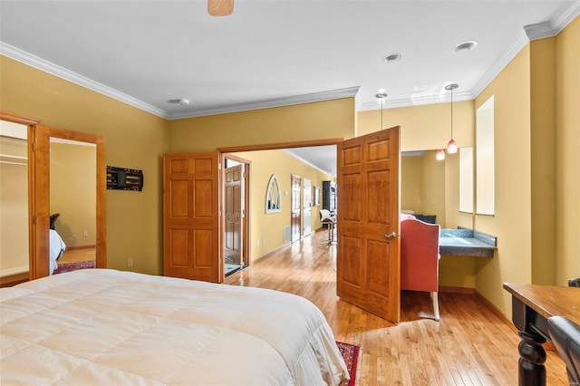 bedroom featuring ornamental molding and light hardwood / wood-style floors