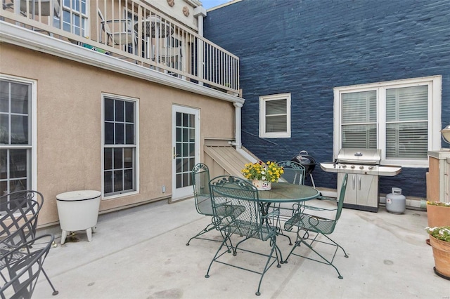 view of terrace with a balcony and a grill