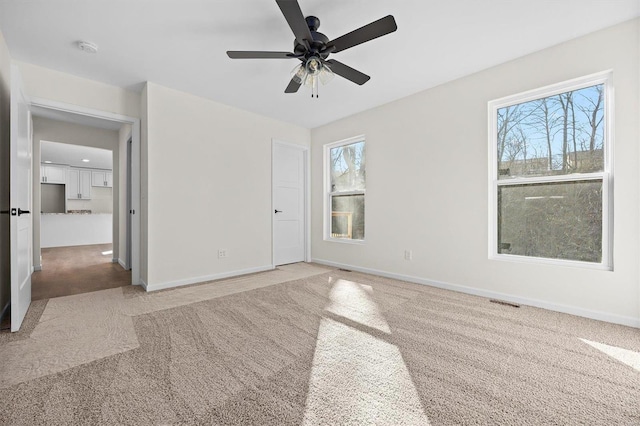 unfurnished bedroom featuring carpet floors and ceiling fan