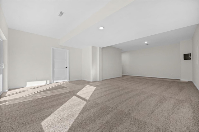 spare room featuring light colored carpet