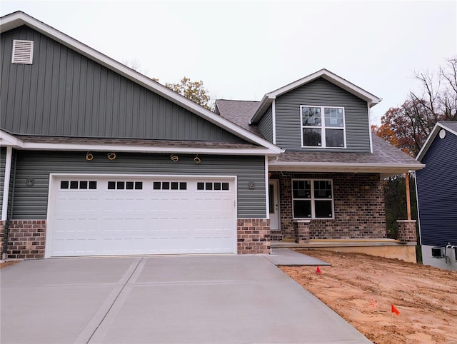 view of front of home featuring covered porch and a garage