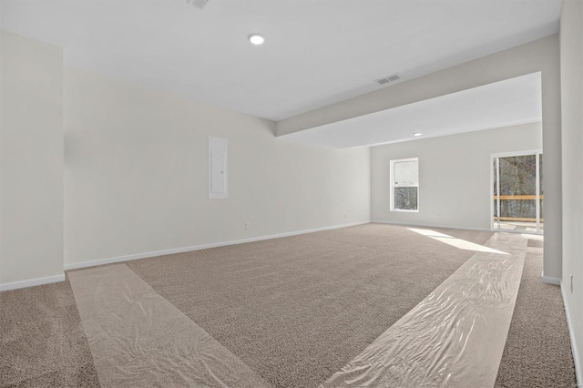 unfurnished room featuring visible vents, baseboards, electric panel, carpet flooring, and recessed lighting