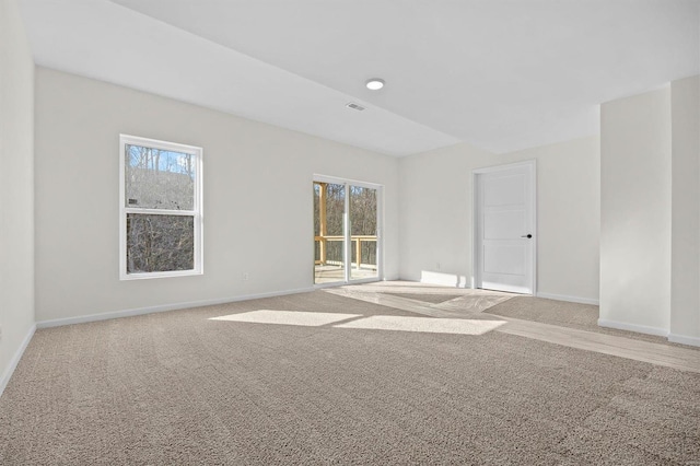 carpeted empty room with visible vents and baseboards