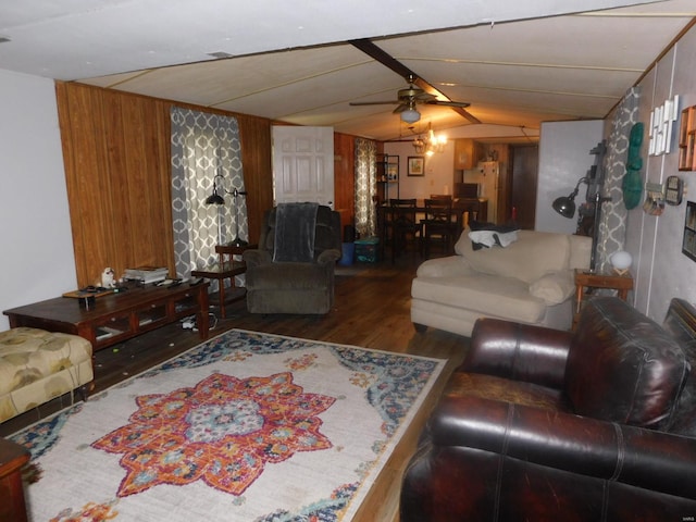 living room featuring ceiling fan, wooden walls, and dark hardwood / wood-style floors