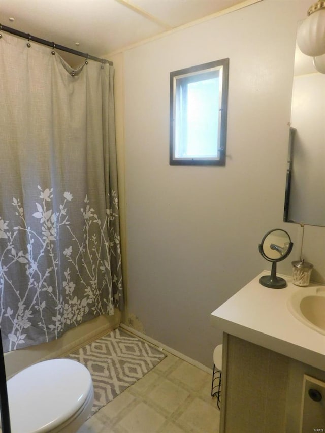 bathroom featuring toilet, tile floors, and vanity