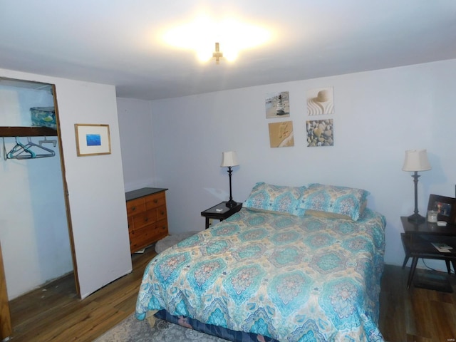 bedroom with dark hardwood / wood-style floors