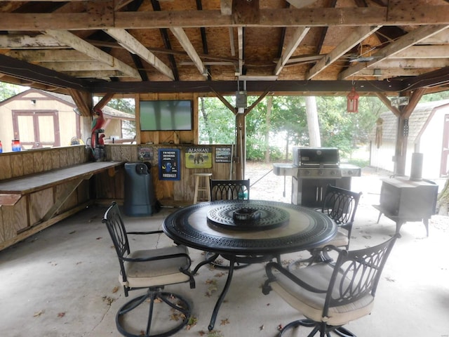 view of terrace with an outdoor kitchen and a grill