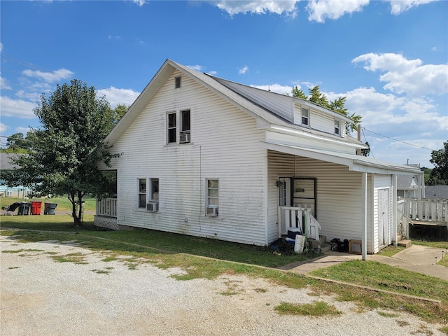 back of property with a lawn