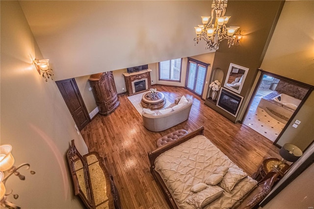 interior space with an inviting chandelier, dark hardwood / wood-style floors, and a towering ceiling