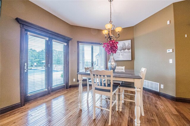 dining space with a chandelier and wood-type flooring