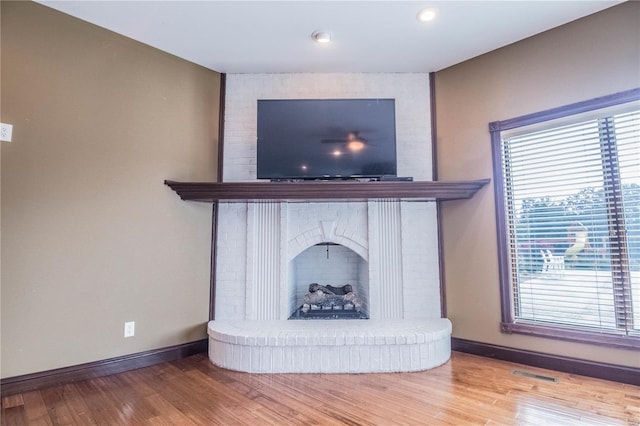 room details featuring hardwood / wood-style floors and a brick fireplace