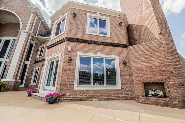 exterior space with an outdoor brick fireplace