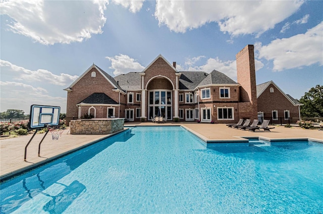 view of swimming pool featuring a patio area