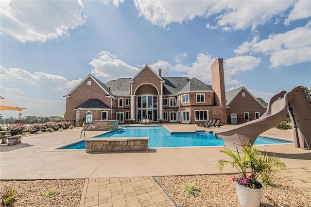 view of pool featuring a water slide and a patio area