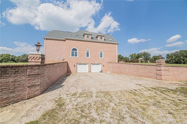 rear view of house featuring a garage