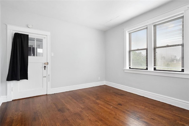 unfurnished room with dark hardwood / wood-style floors