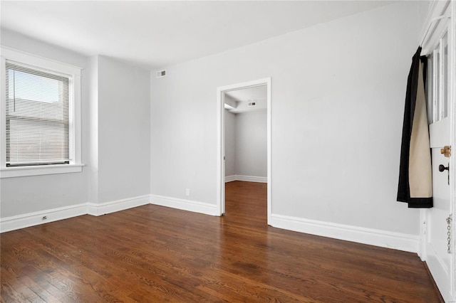 unfurnished room featuring dark wood-type flooring