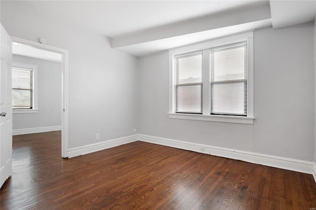 empty room with dark hardwood / wood-style flooring