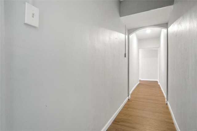 hallway with light hardwood / wood-style floors