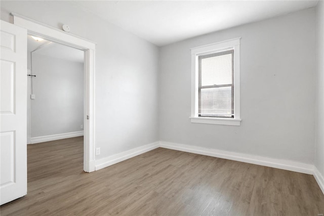 unfurnished room with hardwood / wood-style floors