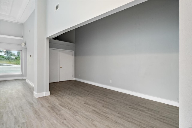 interior space featuring a high ceiling and hardwood / wood-style flooring