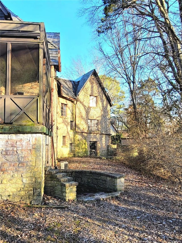 view of side of property with a sunroom