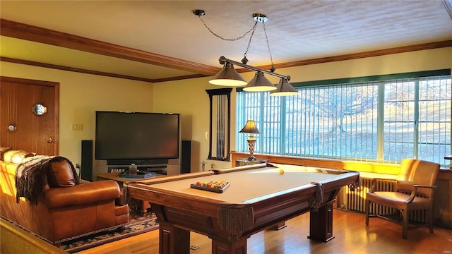 recreation room featuring radiator, ornamental molding, a textured ceiling, pool table, and wood-type flooring