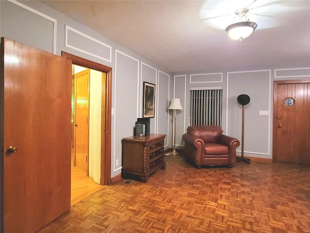 living area featuring parquet flooring