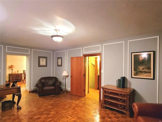 sitting room featuring parquet floors