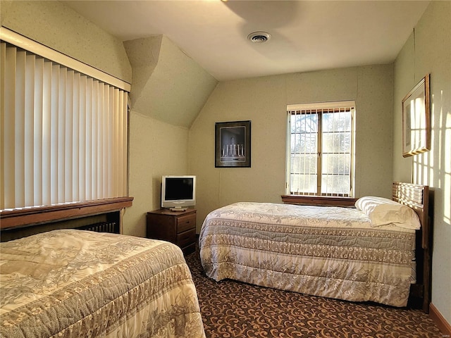 carpeted bedroom with lofted ceiling