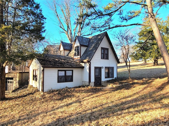 view of side of home with a yard