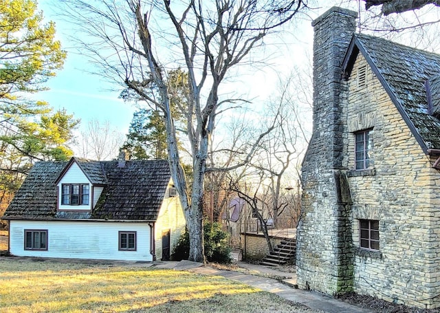 view of property exterior with a lawn