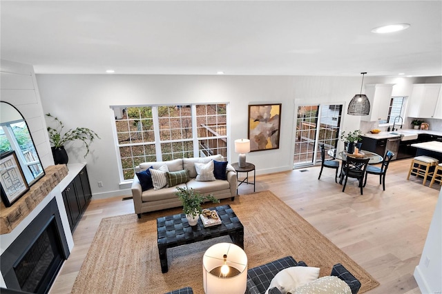 living room featuring light hardwood / wood-style flooring and sink