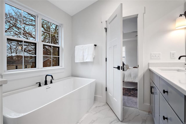 bathroom featuring tile flooring, vanity, and a tub