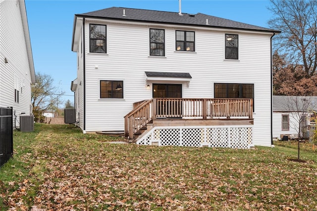 rear view of house with a deck, central AC, and a yard