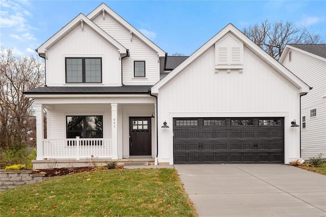 modern inspired farmhouse with a front yard, covered porch, and a garage