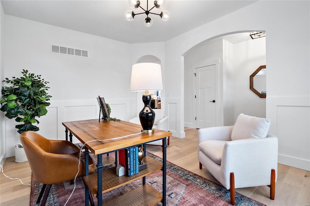 office area with a notable chandelier and light wood-type flooring