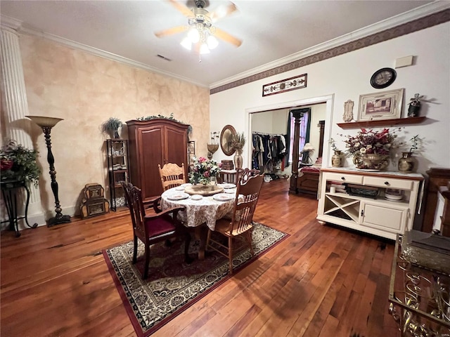 dining room with dark wood-type flooring, ceiling fan, and ornamental molding