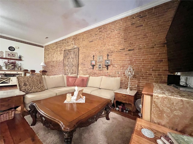 living room with ornamental molding, brick wall, and dark hardwood / wood-style floors