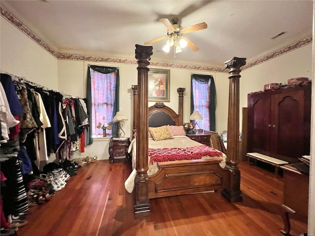 bedroom featuring crown molding, ceiling fan, and dark hardwood / wood-style flooring