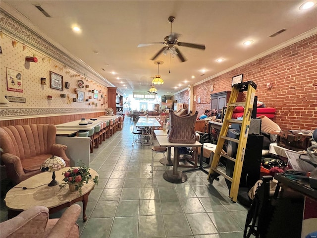 interior space with ceiling fan, crown molding, brick wall, and light tile flooring