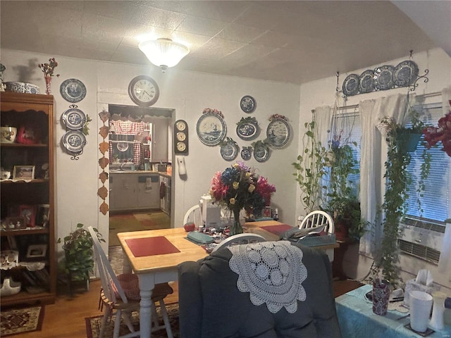 dining space with wood-type flooring