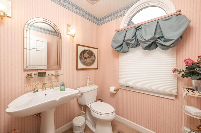 bathroom featuring a textured ceiling and toilet