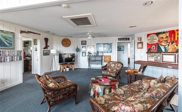 carpeted living room with a textured ceiling and ceiling fan