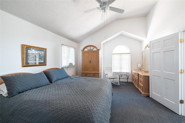 bedroom featuring lofted ceiling, ceiling fan, dark colored carpet, and multiple windows