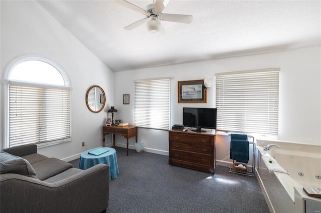 carpeted home office with a textured ceiling, ceiling fan, and lofted ceiling