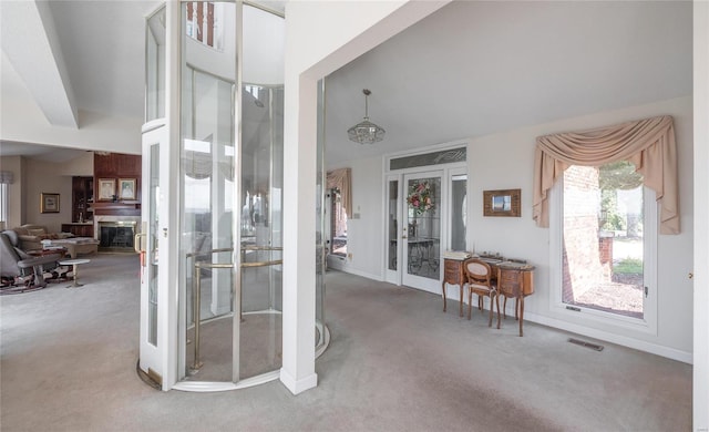 interior space featuring french doors, light colored carpet, and a high ceiling