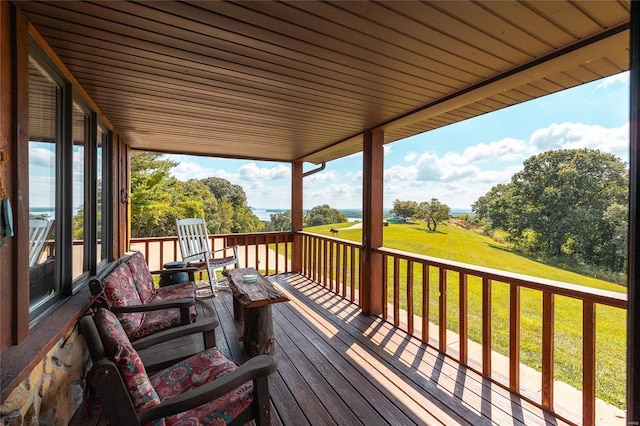 wooden terrace featuring a yard