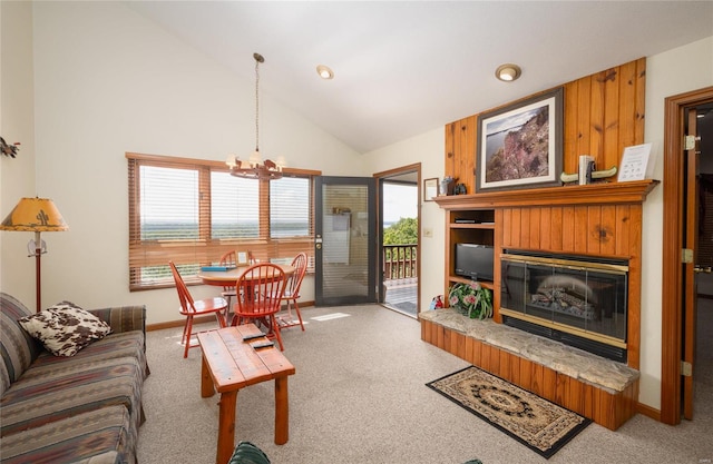 living room with an inviting chandelier, plenty of natural light, high vaulted ceiling, and carpet floors